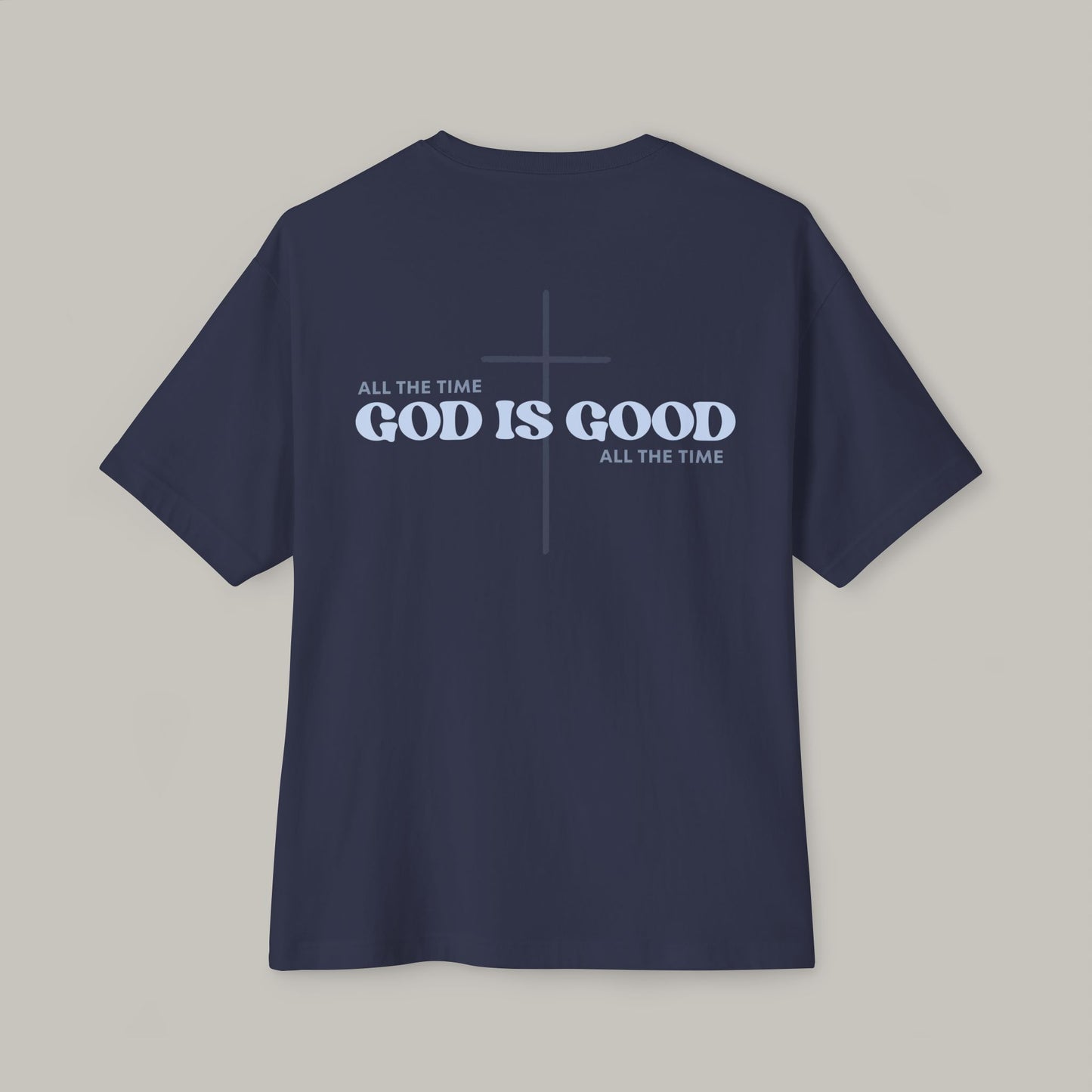 Navy blue t-shirt with 'GOD IS GOOD ALL THE TIME' text on a gray background