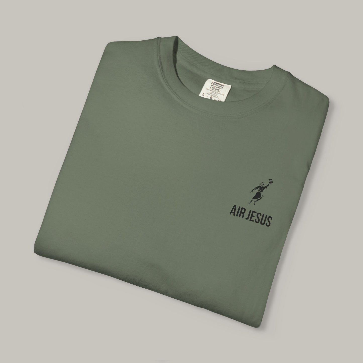 Folded green t-shirt with 'Air Jesus' logo on a gray background