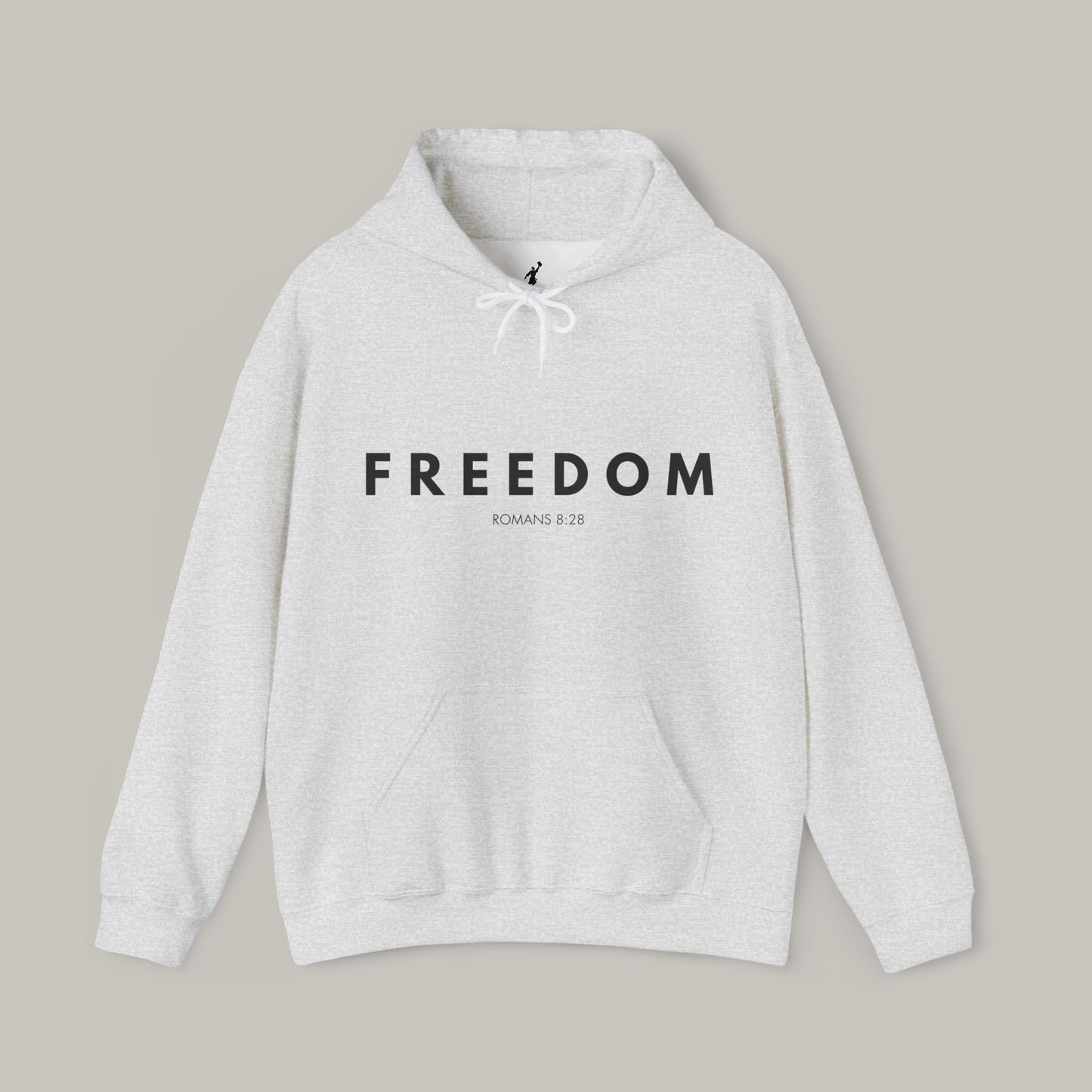 Gray hoodie with 'FREEDOM' text on a beige background