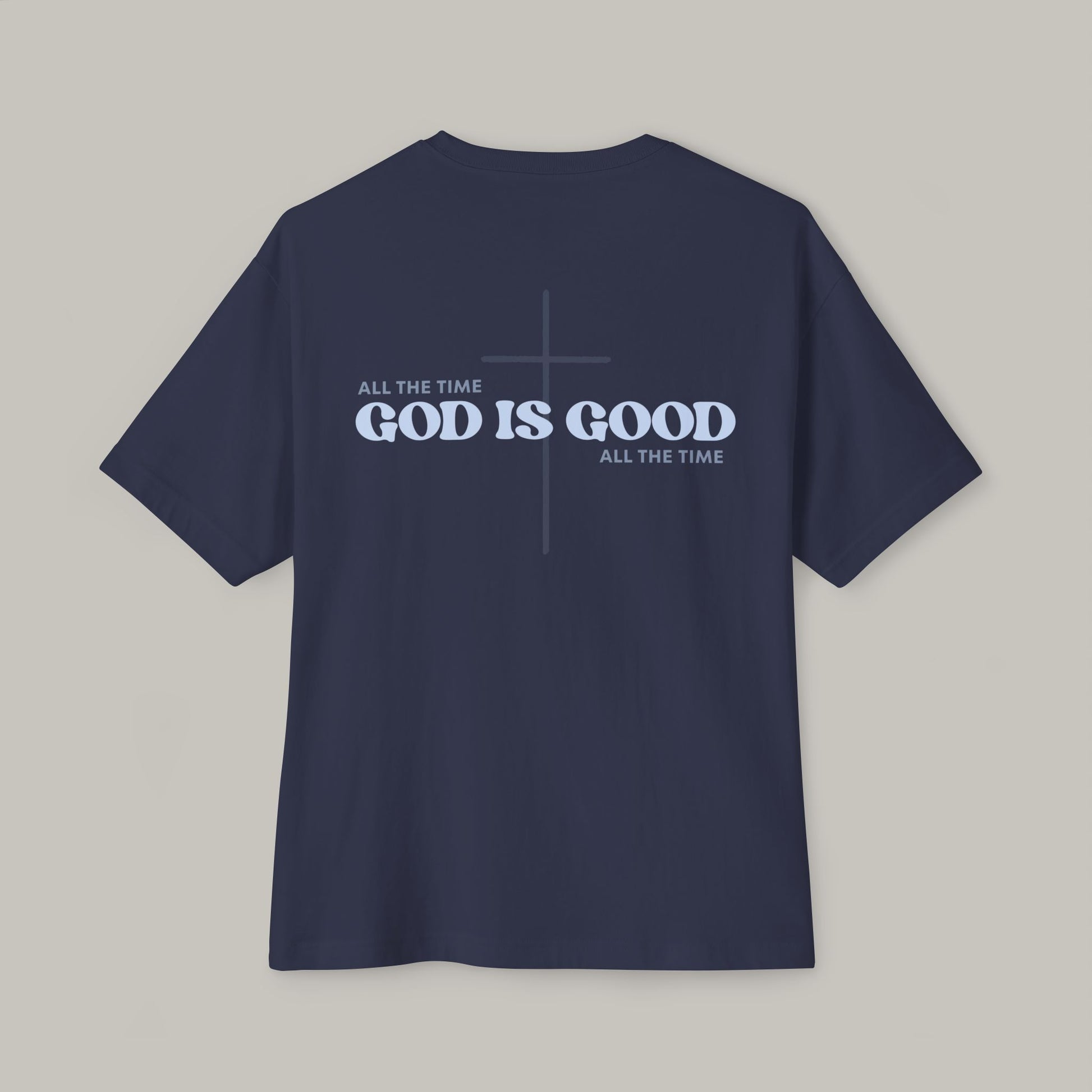 Navy blue t-shirt with 'GOD IS GOOD ALL THE TIME' text on a gray background