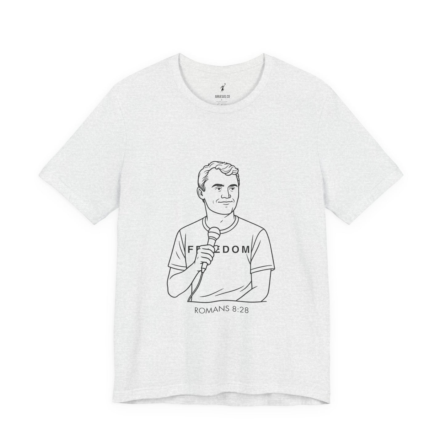 White t-shirt with black line art of Charlie Kirk holding a microphone and text 'Freedom Romans 8:28' on a white background