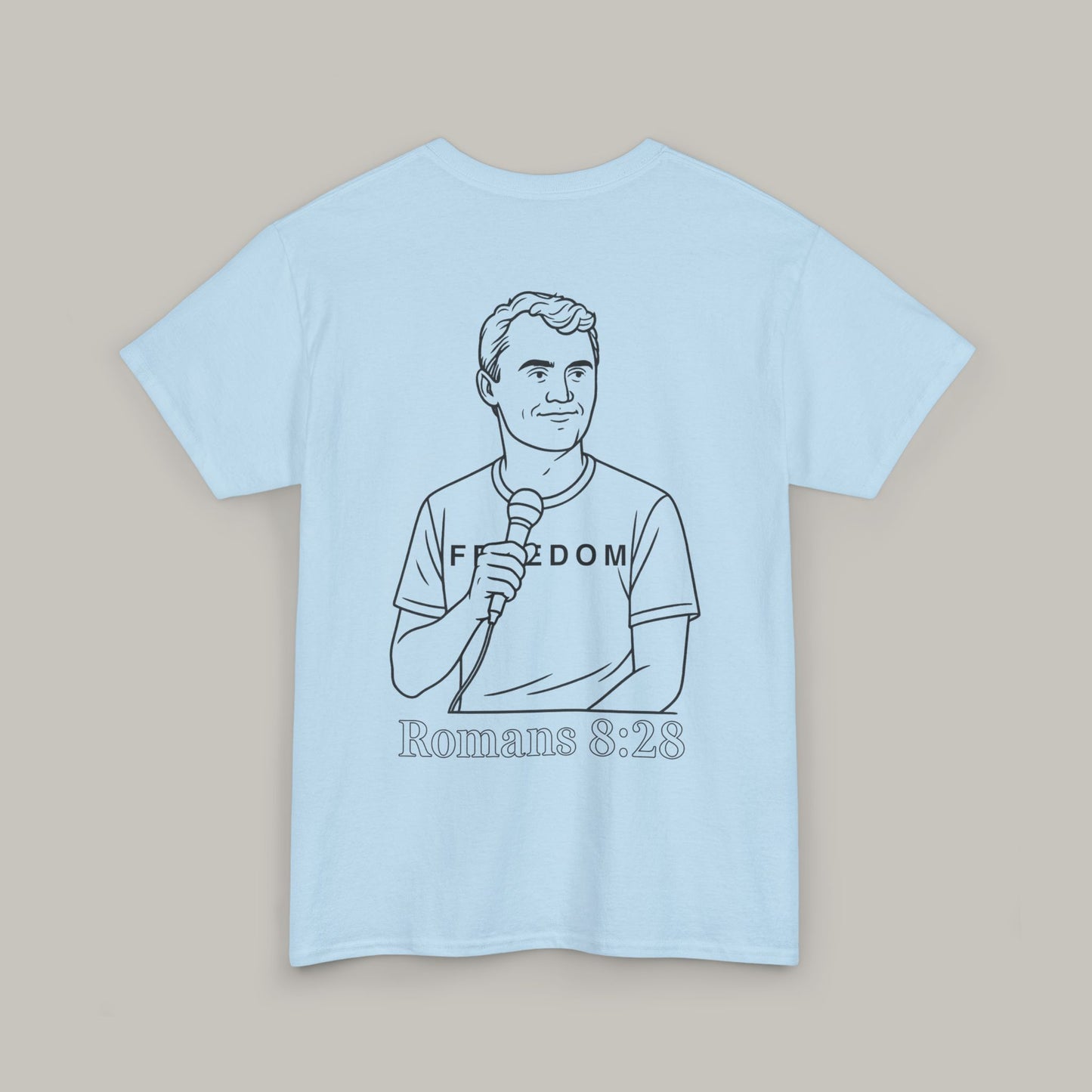 Light blue t-shirt with a graphic of a person holding a microphone and text on a beige background