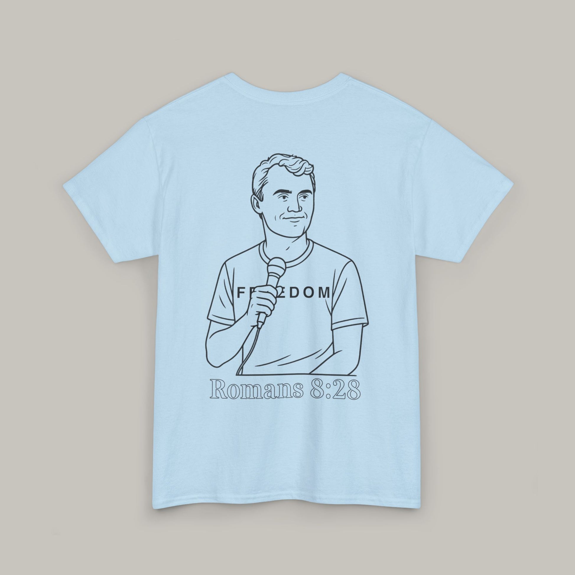 Light blue t-shirt with a graphic of a person holding a microphone and text on a beige background