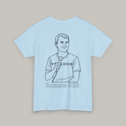 Light blue t-shirt with a graphic of a person holding a microphone and text on a beige background