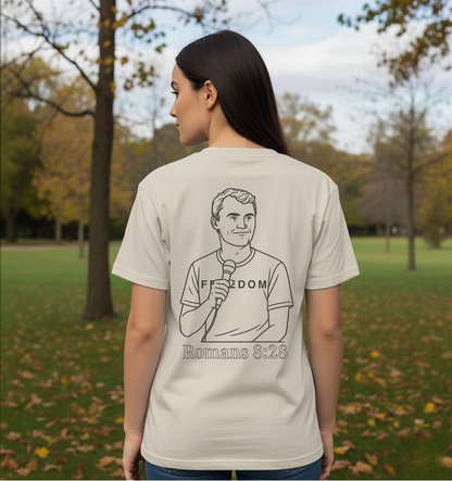 Person wearing a t-shirt with a graphic and text in a park