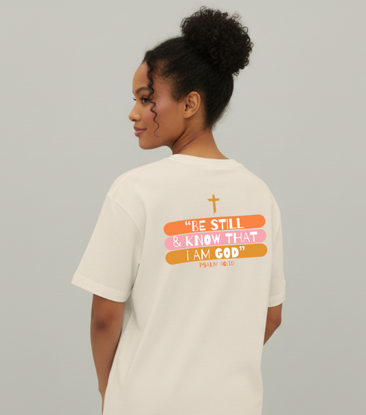 Person wearing a white t-shirt with a motivational quote on the back against a plain background