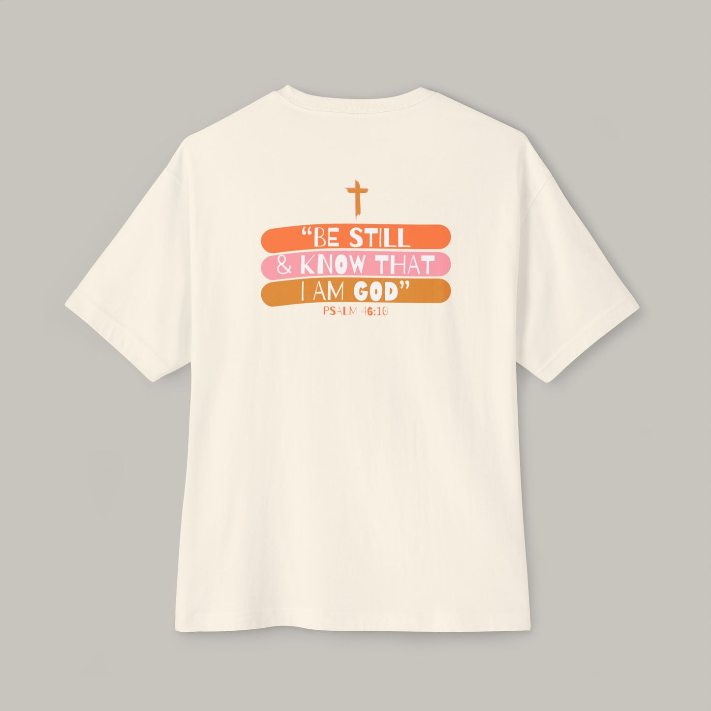 White t-shirt with motivational quote and cross design on a gray background