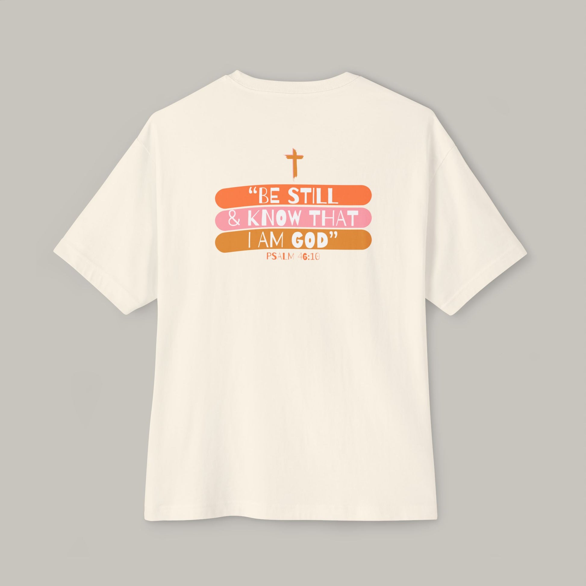 White t-shirt with motivational quote and cross design on a gray background