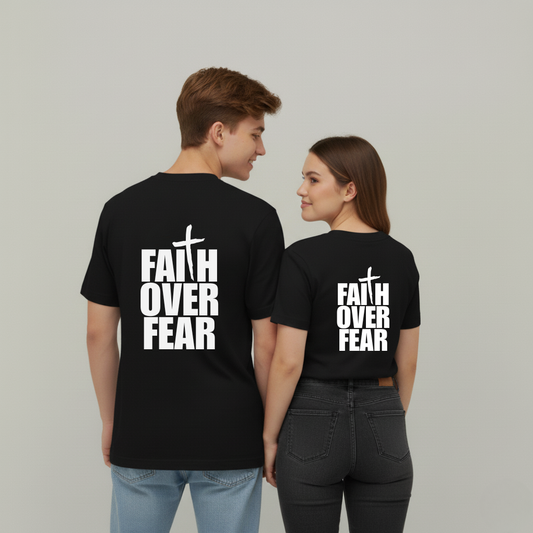 Two people wearing black t-shirts with 'Faith Over Fear' text on a plain background