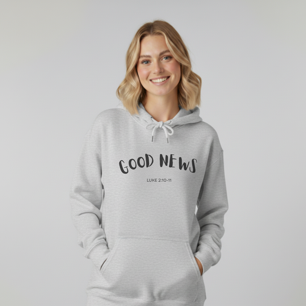 Woman wearing a gray hoodie with 'GOOD NEWS Luke 2:10-11' text on a plain background