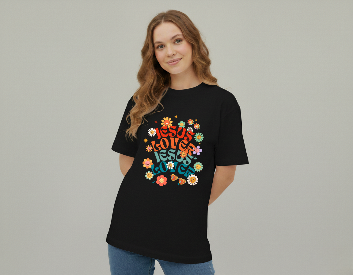 Woman wearing a black t-shirt with colorful 'Jesus Loves Jesus Loves' design on a plain background