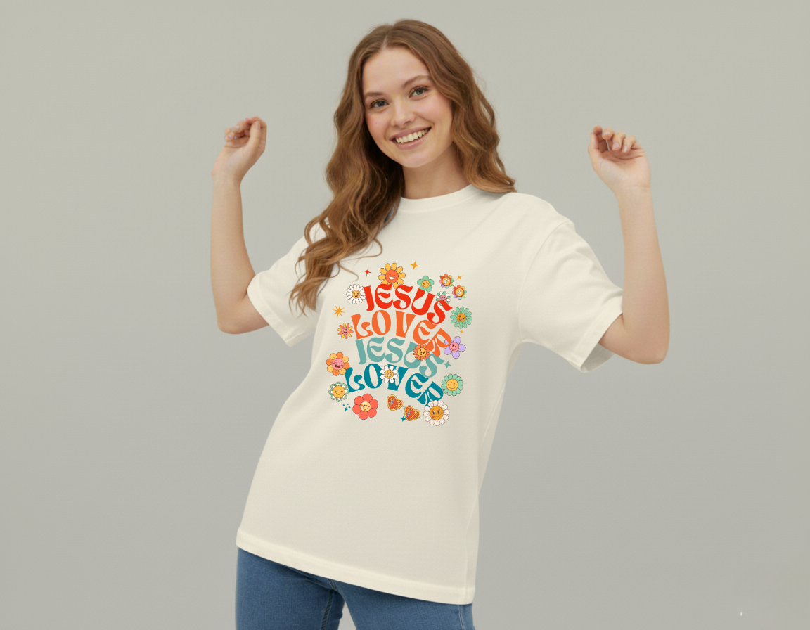 Woman wearing a white t-shirt with colorful text and graphics on a plain background