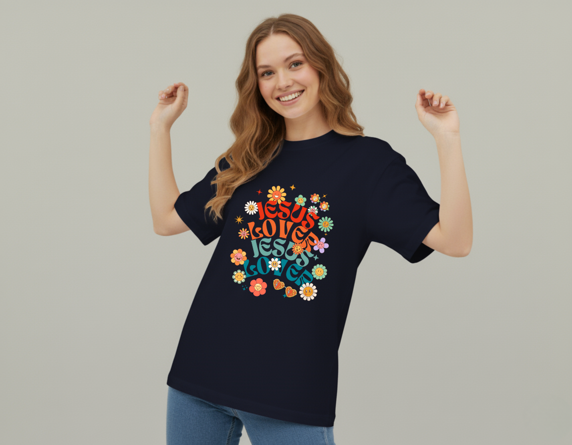 Woman wearing a black t-shirt with colorful text and flowers on a plain background