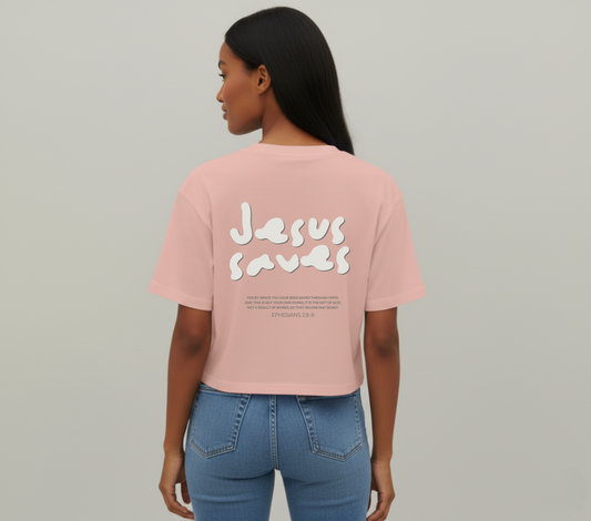 Person wearing a pink t-shirt with 'Jesus Saves' text on the back, standing against a plain background.