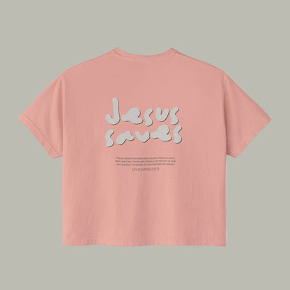 Pink t-shirt with 'Jesus saves' text on a white background
