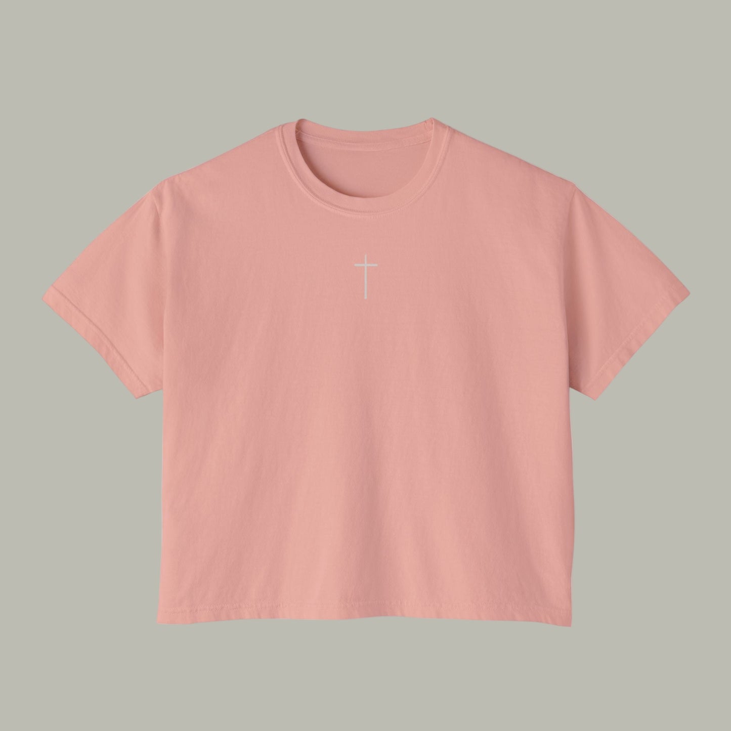 Pink t-shirt with a white cross on a white background