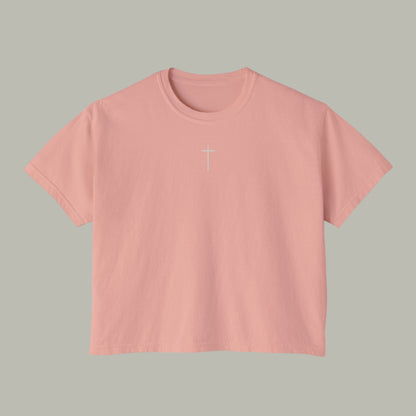 Pink t-shirt with a white cross on a white background