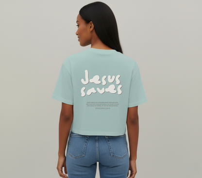 Person wearing a light blue t-shirt with 'Jesus Saves' text on the back, standing against a plain background.