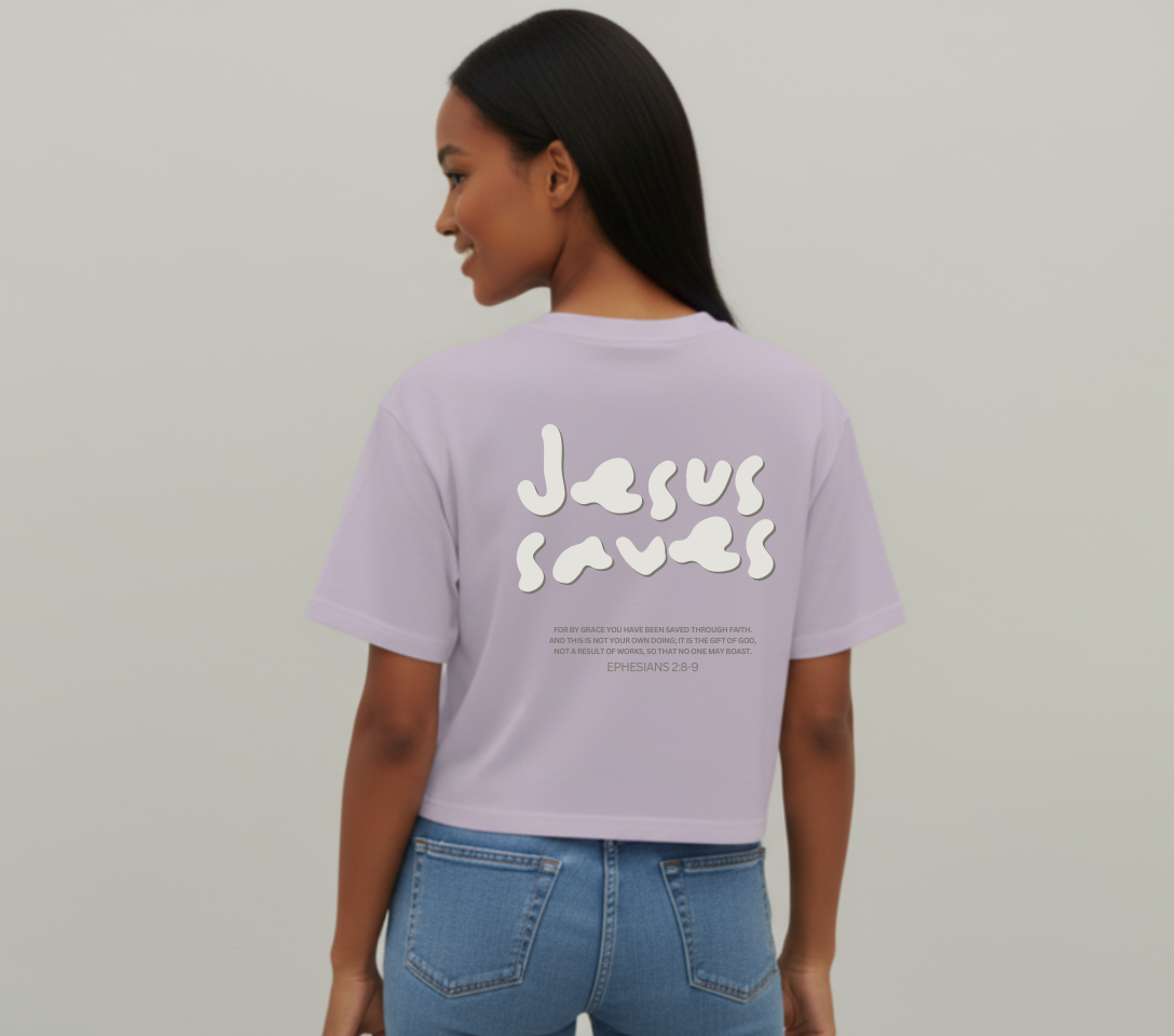 Person wearing a lavender t-shirt with 'Jesus Saves' text on the back, standing against a plain background.
