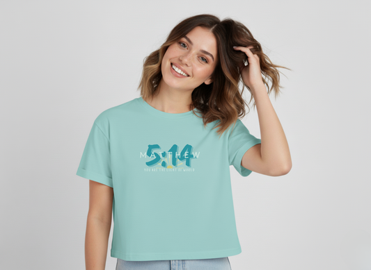 Woman wearing a light blue a Matthew 514 Croptop  with text on a plain background