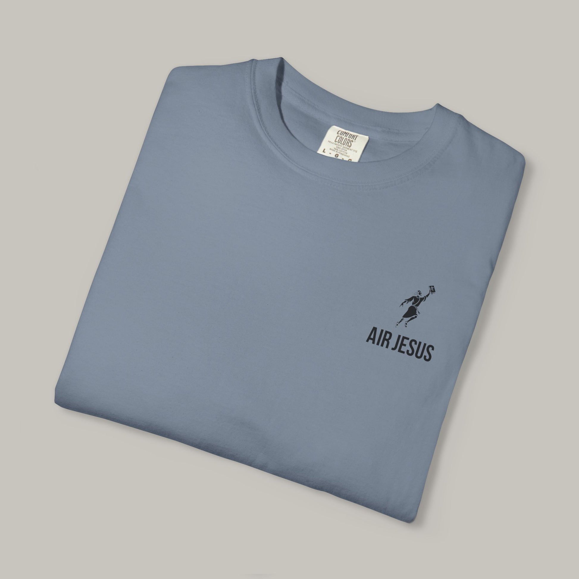 Folded blue t-shirt with 'Air Jesus' logo on a gray background