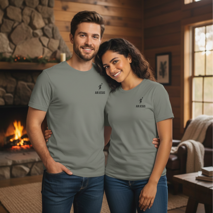 Man and woman wearing matching gray t-shirts in a cozy room with a fireplace.