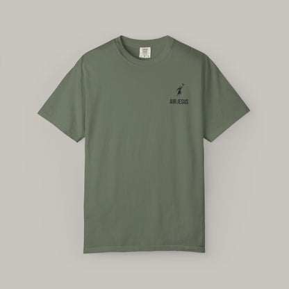 Green t-shirt with a small logo on a gray background