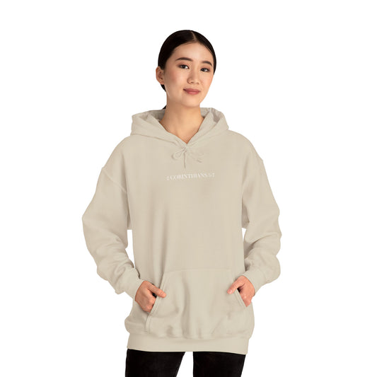 Person wearing a beige hoodie with text on a white background